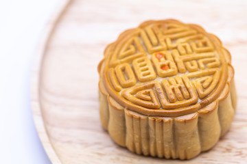 Close up of chinese moon cake on wooden plate background.