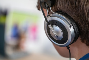 Boy listens to music on his on head phones