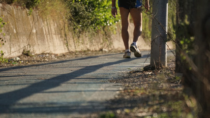 running at the park with a warm morning light, runner on a blurry country background
