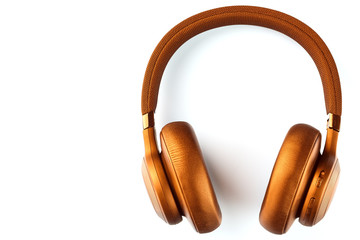 Golden bluetooth headphones on a white background top view, isolate. In-Ear Headphones for DJs