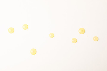 Honey drops on white background, space for text