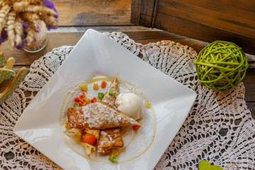 cake on a white plate on an embroidered napkin on the windowsill