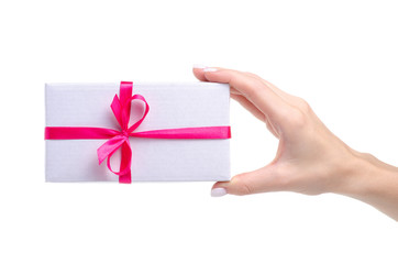 White box with pink ribbon bow gift in hand on white background isolation