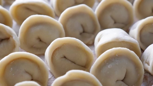 Homemade meat dumplings, closeup. Russian traditional meal. Rotate