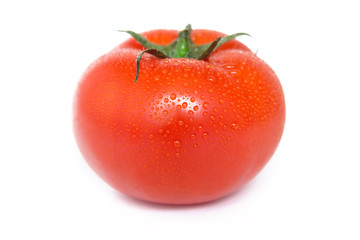 A ripe red tomato with water drops  isolated on a white background сlose up. 