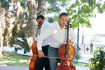 Street musicians in big city playing on instrument