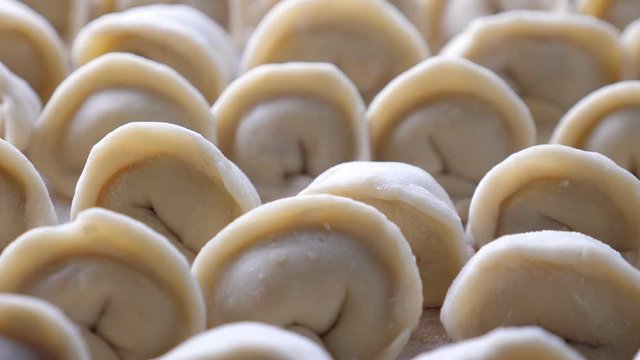 Homemade meat dumplings, closeup. Russian traditional meal. Rotate