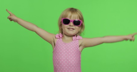 Child in pink swimsuit doing sports exercises, girl fitness training and dancing