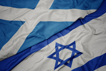 waving colorful flag of israel and national flag of scotland.