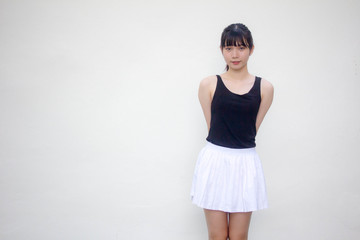Portrait of thai adult beautiful girl black shirt white skirt relax and smile