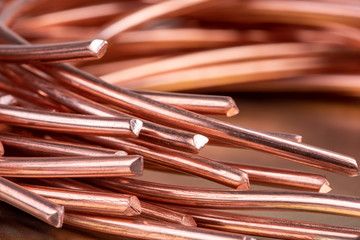 Copper wire on shiny metallic surface close-up