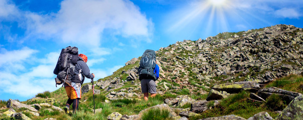 traveller on the way to rocks at sunny day. panoramic view