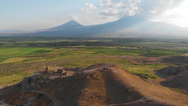 Khor Virap with Mount Ararat in background. The Khor Virap is an Armenian monastery located in the Ararat plain in Armenia, near the border with Turkey. Aerial flight video