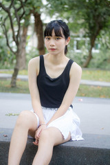Portrait of thai adult beautiful girl black shirt white skirt relax time