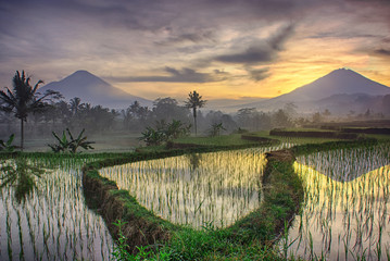Mountain Sumbing and Sindoro landscape with sunrise reflection on water at Wonosobo Central java Indonesia