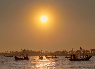 Sailing fisherman ships on the sea at sunset