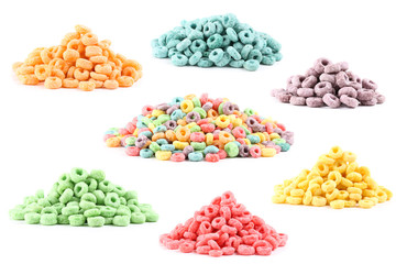 Collage of different colorful corn flakes on white background