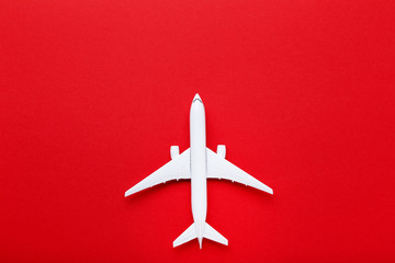 Airplane model on red paper background