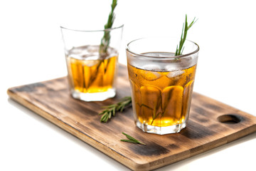 glasses of soda with lemon and rosemary on a bamboo board