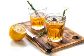 glasses of soda with lemon and rosemary on a bamboo board