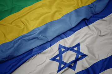waving colorful flag of israel and national flag of gabon.