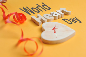 World Heart Day Concept. Shape Heart symbol and heart text created off wood