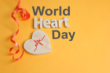 World Heart Day Concept. Shape Heart symbol and heart text created off wood
