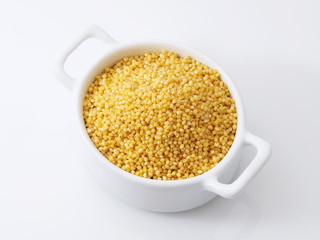 Dry millet groats in ceramic bowl