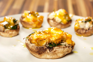 Portion of tasty heathy meal of mushrooms served on plate in kitchen