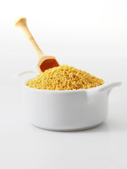 Dry millet groats in ceramic bowl