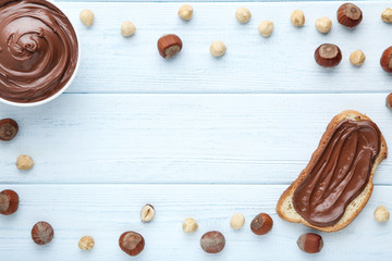 Naklejka na ściany i meble Melted chocolate with hazelnuts and bread on wooden table