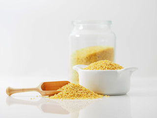 Dry millet groats in ceramic bowl