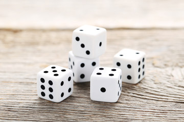 White dice on grey wooden table