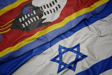 waving colorful flag of israel and national flag of swaziland.