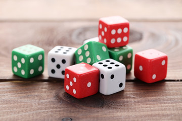 Colourful dice on brown wooden table