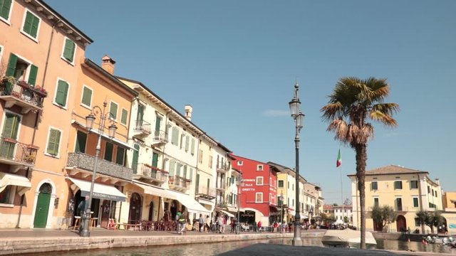 people walking in a beautiful italian village in the Garda Lake