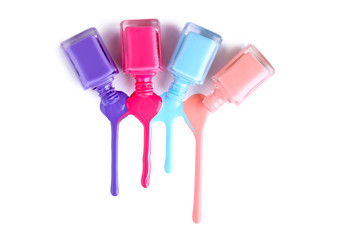 Nail polish splatters and bottles on white background