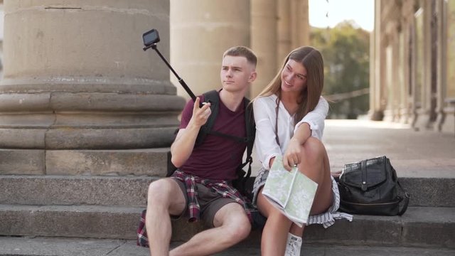 Young tourist couple posing for a camera on a selfie stick