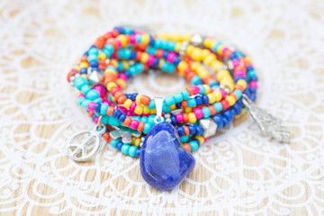 boho beads necklace or bracelet with sodalite mineral stone on decorative wooden background