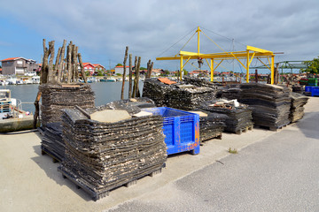 Obraz premium Oyster bags at ostreicole harbor of La Teste de Buch, commune is a located on the shore of Arcachon Bay, in the Gironde department in southwestern France.
