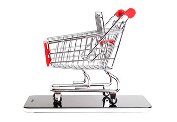 Supermarket trolley and smartphone on white background