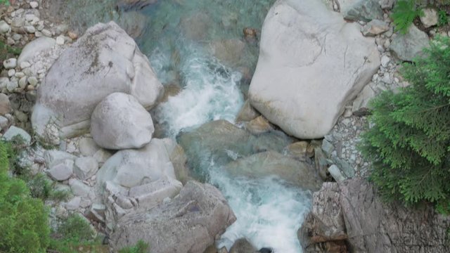 Aerial drone shot: following the flow of the running water of a river. Location: Tatra national park and Morskie oko near Zakopane city, Poland.