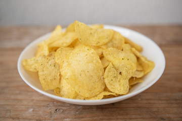 chips in a white plate on a white background