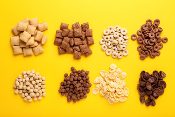Various corn flakes on yellow background