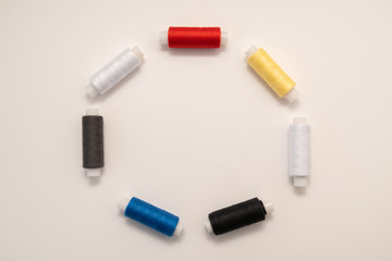 Set of sewing threads beautiful color (blue,yellow, green, white, black) on white background with space for text