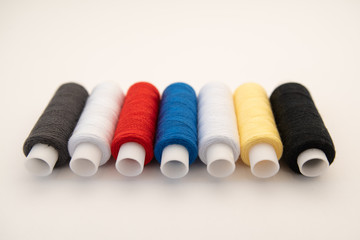 Set of sewing threads beautiful color (blue,yellow, green, white, black) on white background with space for text