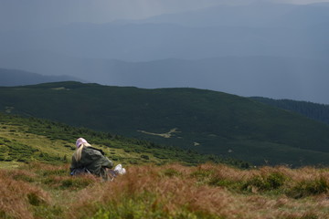 Tourist standing on Carpathian Mountains overlooking the Goverla view