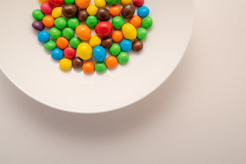 multicolored candies on a white plate