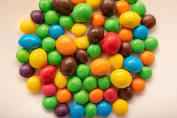 Fototapeta na wymiar multicolored candies on a white plate