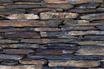 Detail of a wall of slate stones